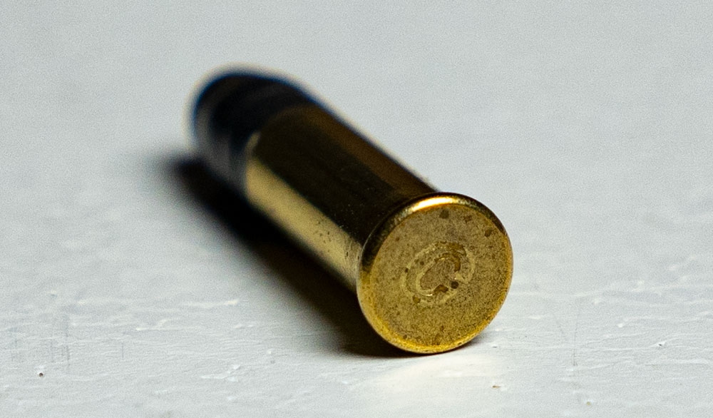 a rimfire ammo cartridge on a table