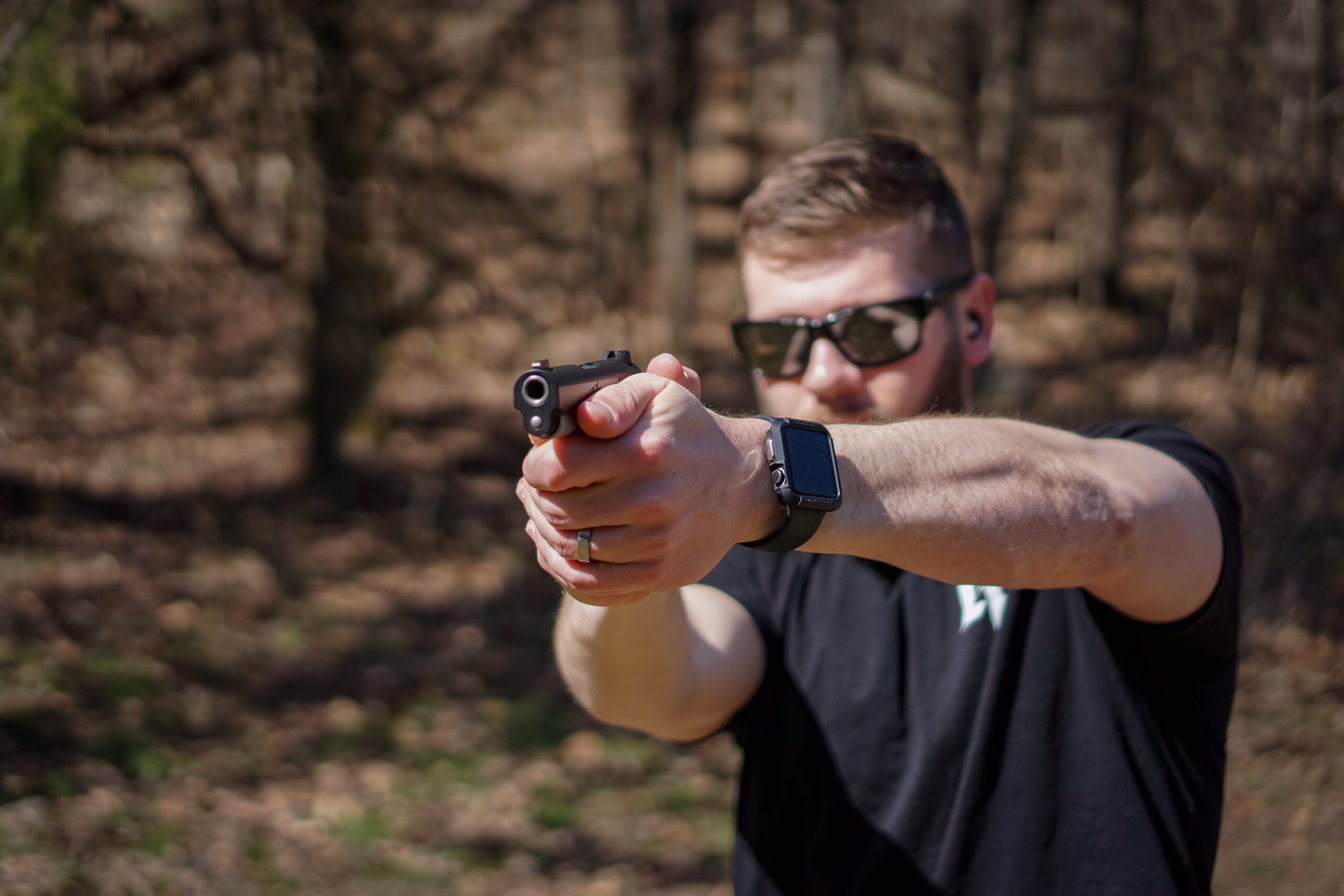 The author firing the Kimber Micro 9 Carry at a shooting range