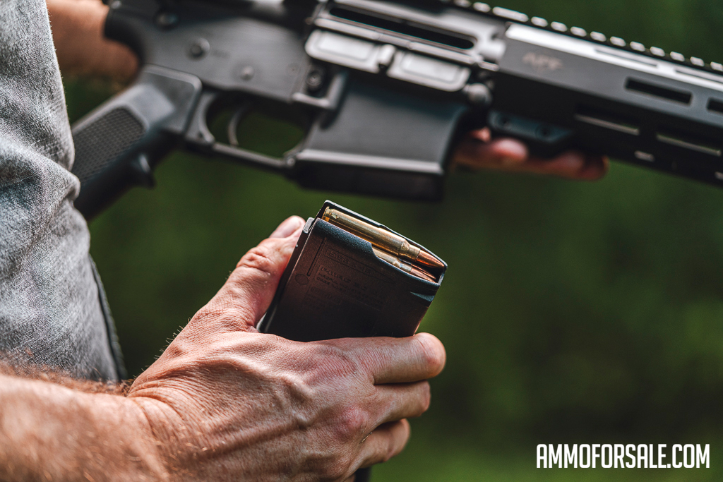 Placing a magazine into the mag well while reloading an AR-15 