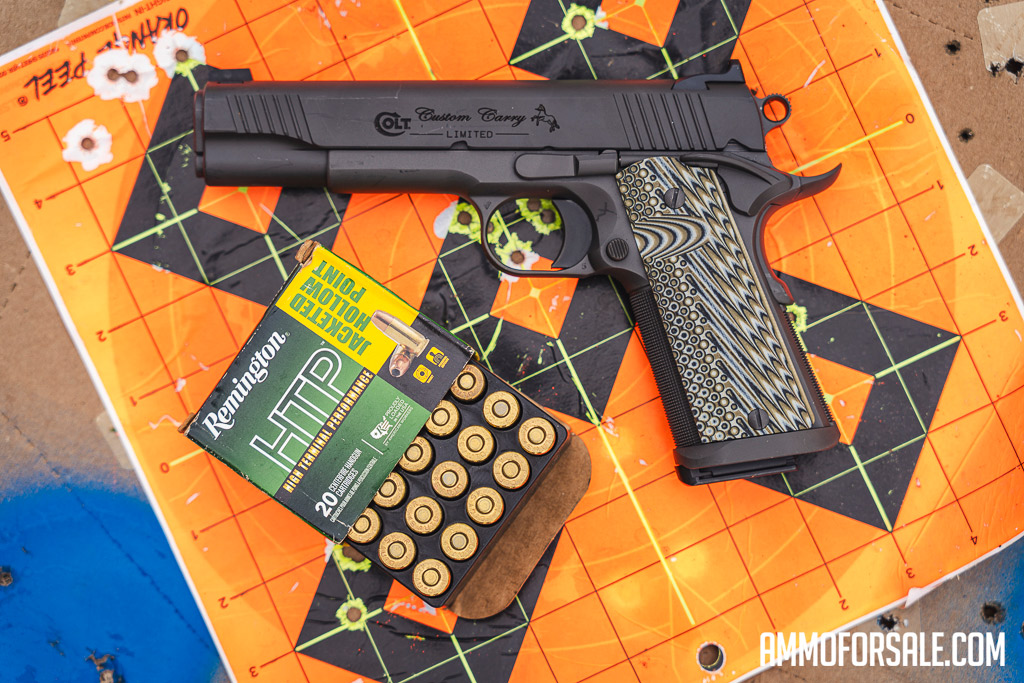 1911 pistol with ammo laying on top of a target