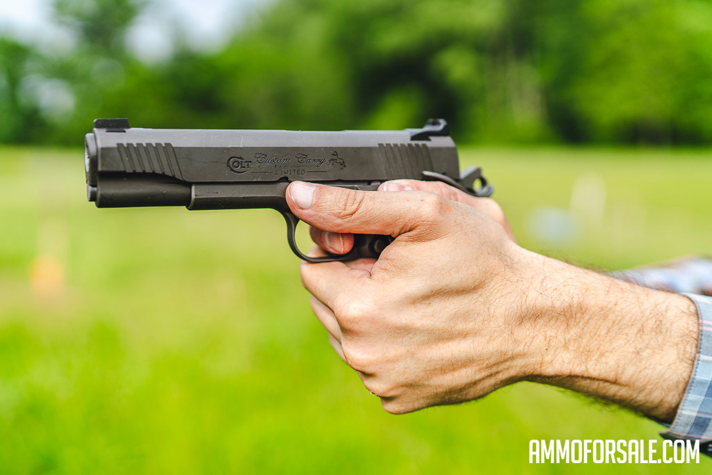 Shooting a 1911 at a shooting range.