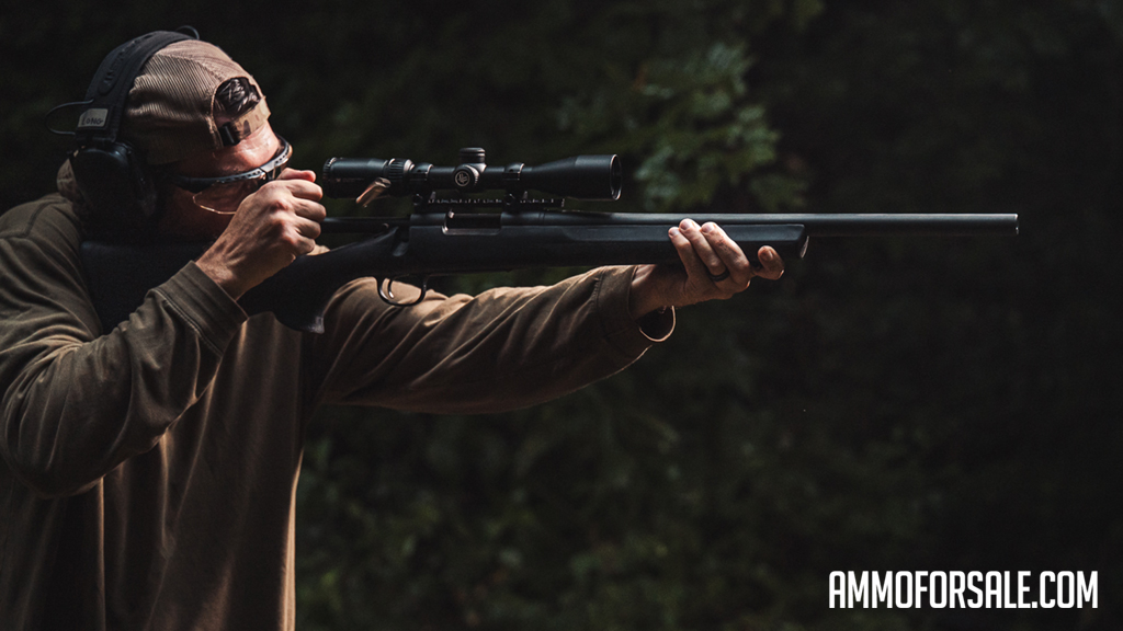 Shooting a rifle A shooter at the shooting range firing a rifle with scirocco bullet loaded ammo