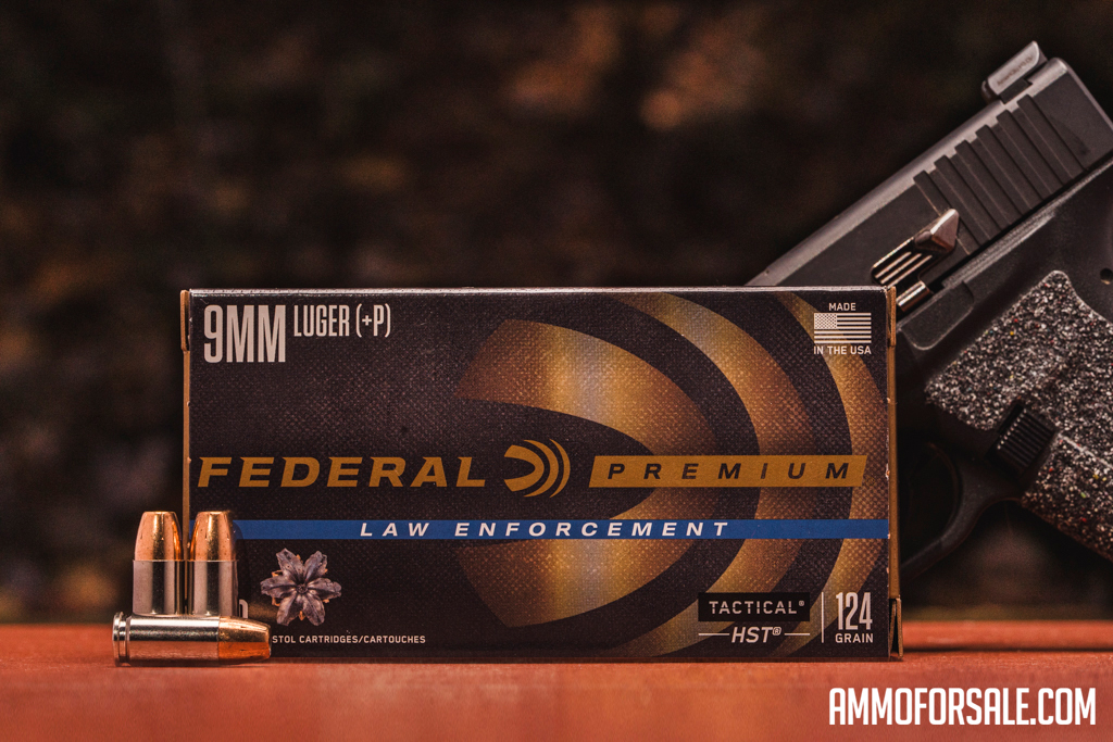 Federal 9mm HST ammo displayed with a pistol at the range