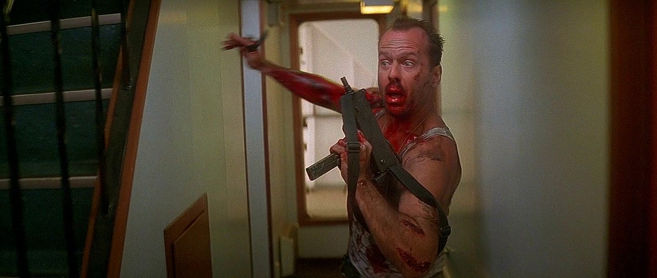 Bruce Willis in Die Hard With a Vengeance carrying a Mac-10