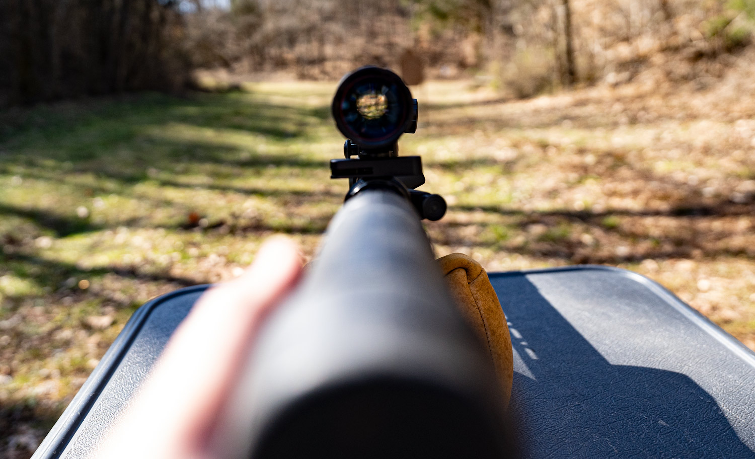 Looking down the scope of a rifle at a shooting range