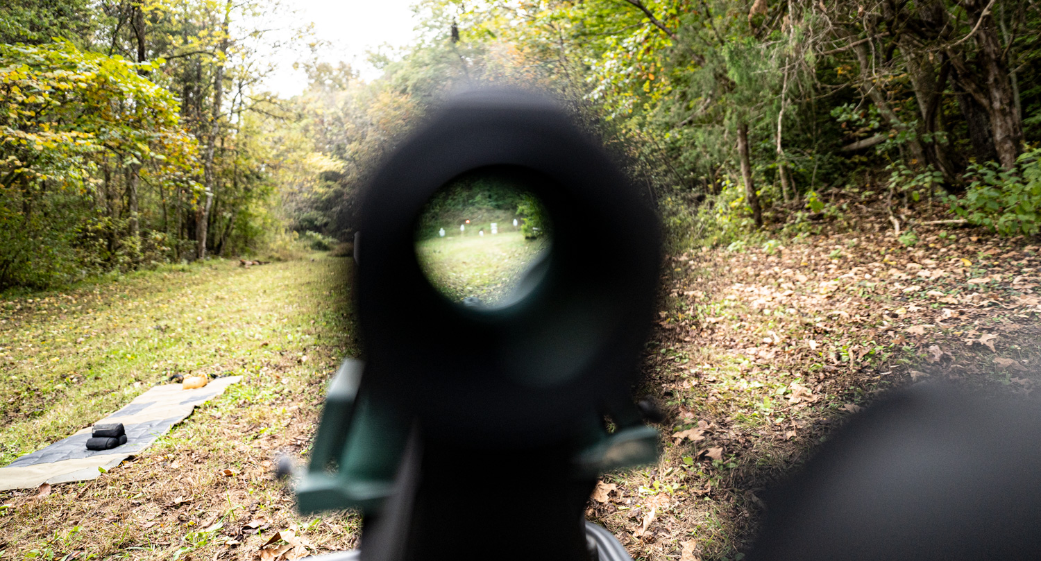 Looking through a rifle scope down range