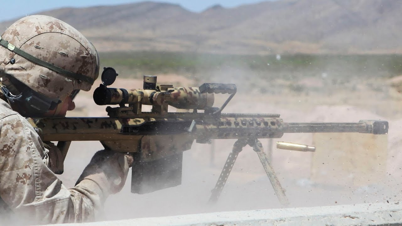 Soldier firing a rifle and kicking up dust