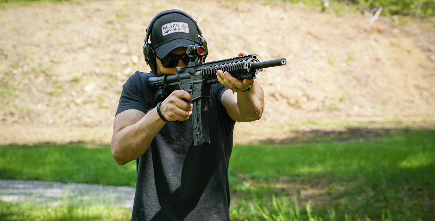 The author shooting an ar-style AR-15 rifle at the range