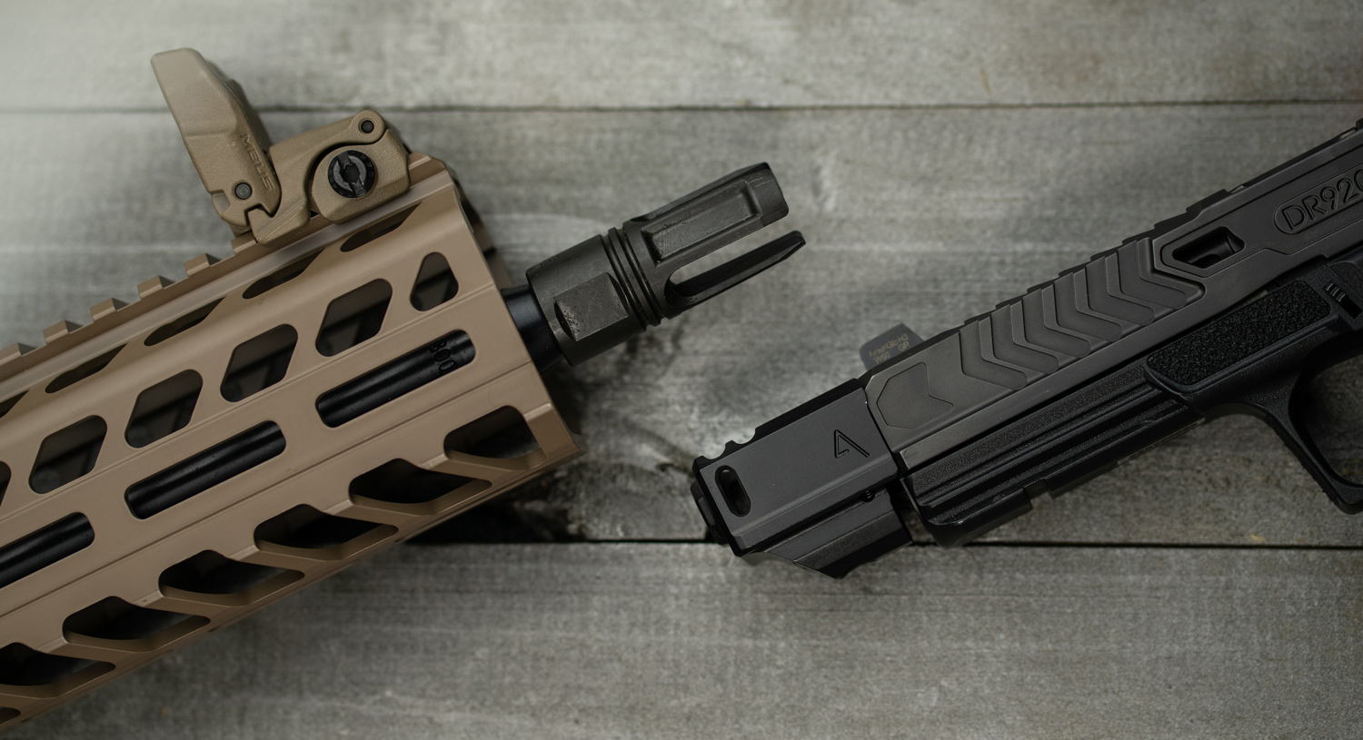 A rifle with a flash hider and a pistol compensator side by side